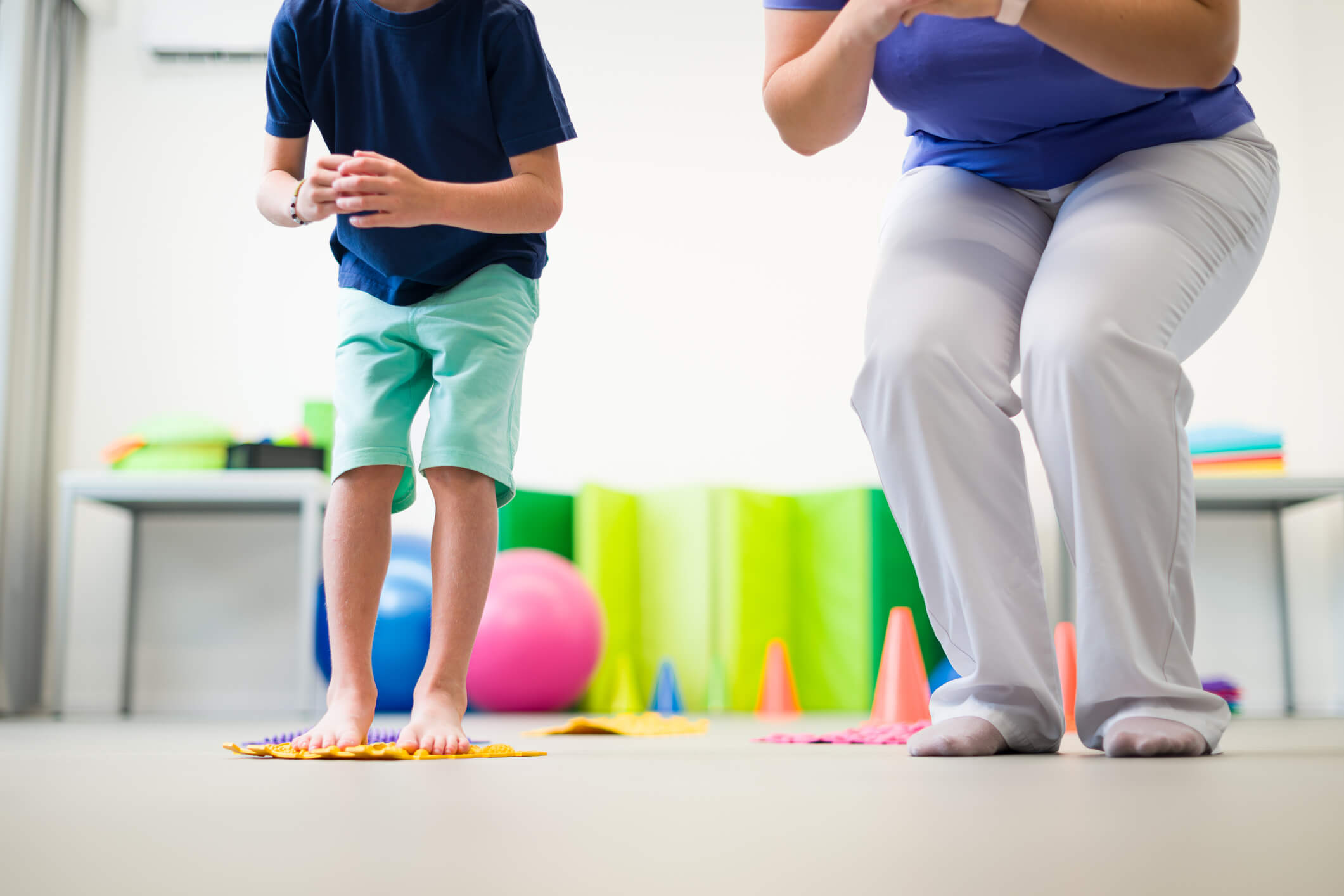 An occupational therapist and a child performing exercises